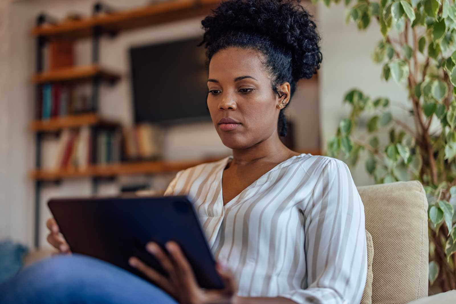 Lady using her tablet computer at home.
